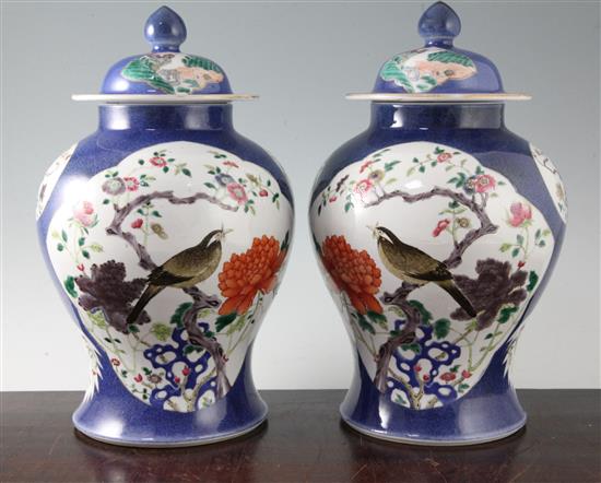 A pair of Chinese famille rose powder blue ground jars and covers, Kangxi marks, early 20th century, height 31.5cm